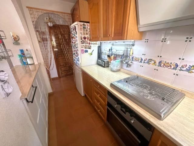 Kitchen before renovation with original tiles