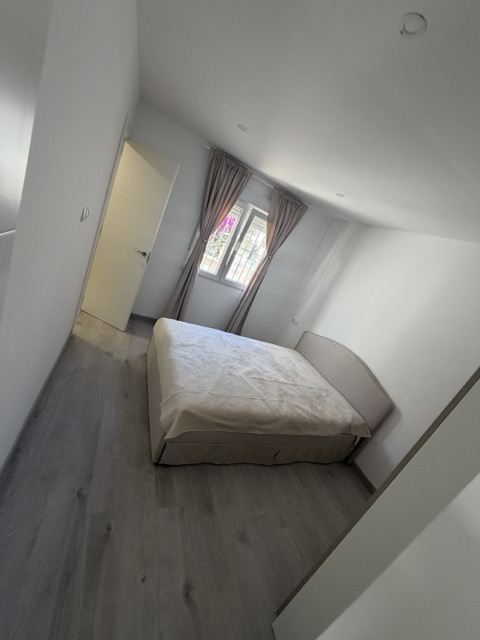 Bright bedroom with soft natural light and curtains