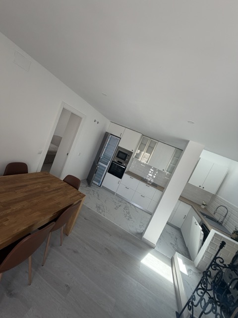 Dining area with solid wood table opening onto the kitchen