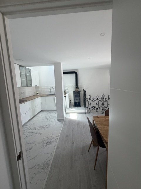 Open-plan living and kitchen area with wood-burning stove