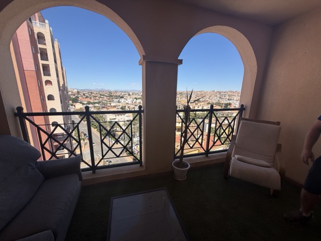 Living room with arched balcony and sea view