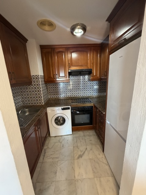 Kitchen with mosaic backsplash and marble flooring