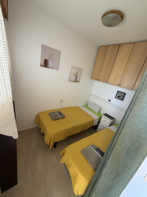Bedroom with twin beds and storage